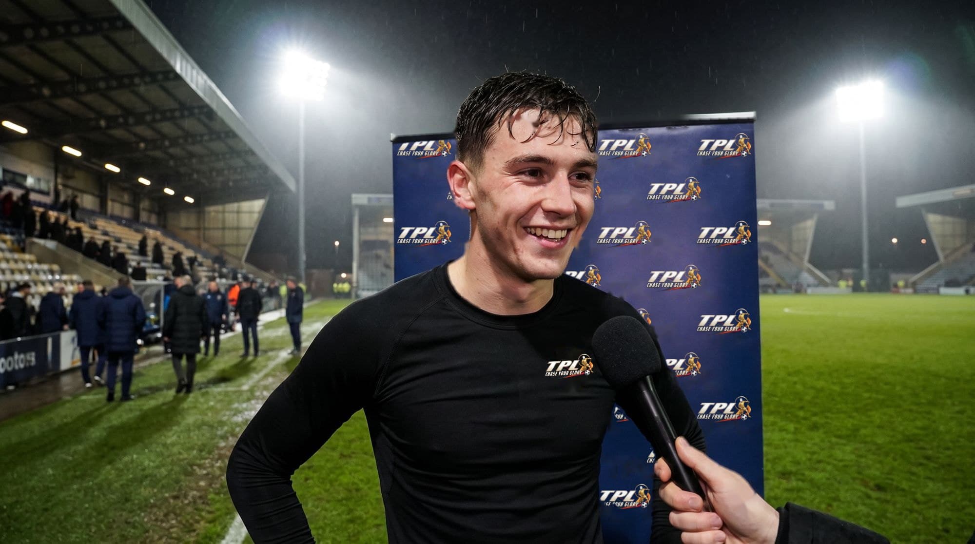 A TPL player gives a pitch-side interview after the match
